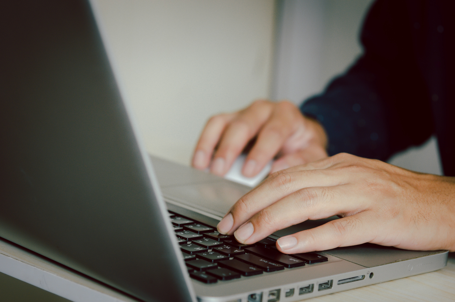 Person Typing on a Laptop